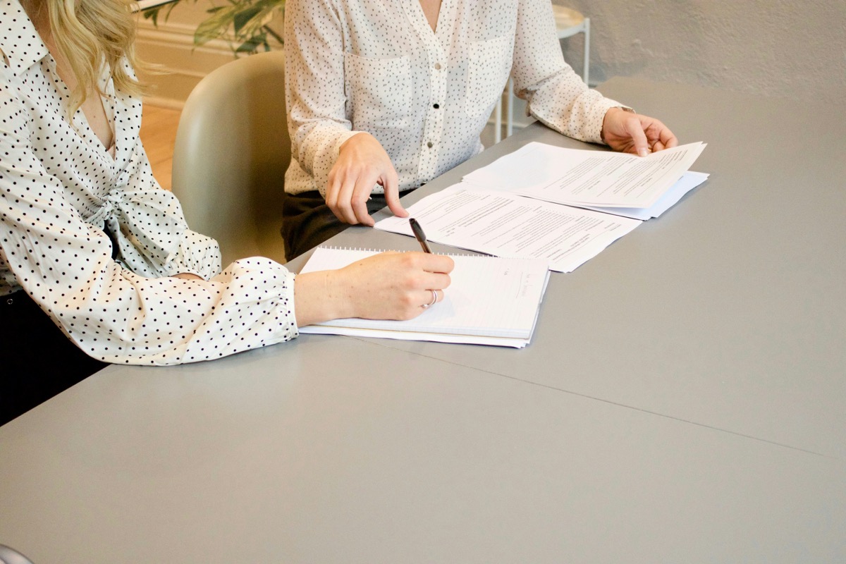 Business professionals reviewing documents and strategizing at a conference table